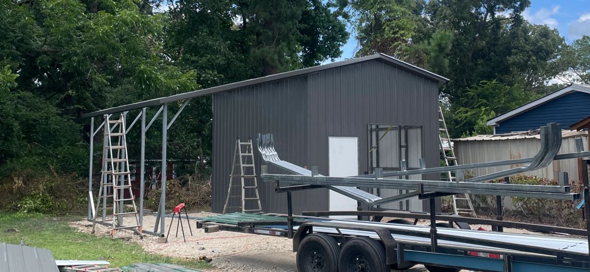 Yardmaster Creations metal building under construction - charcoal building with lean-to frame going up